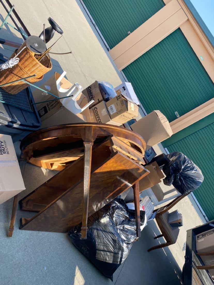 Furniture and bags staged for junk removal